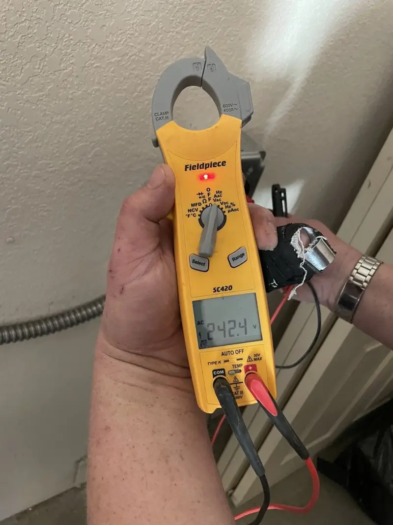 Voltage testing with clamp meter during Outlet Installation in Sebastian